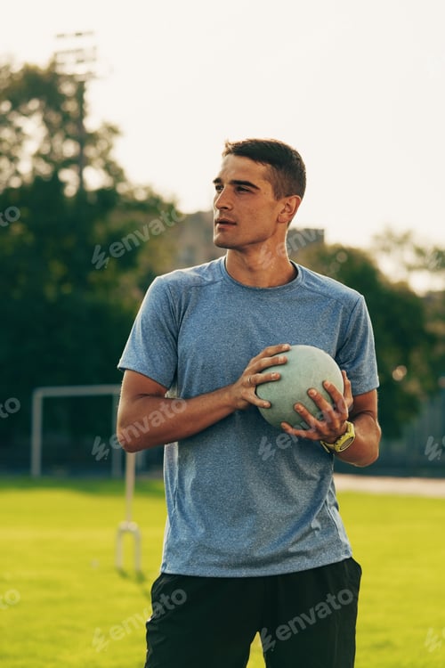 Preview: Young athlete prepares for a training session on a sunny day in a sports field