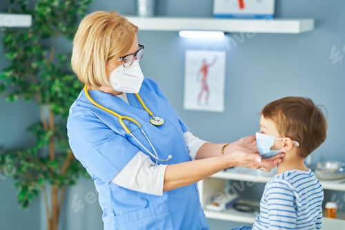 Preview: Pediatrician doctor examining little kids in clinic