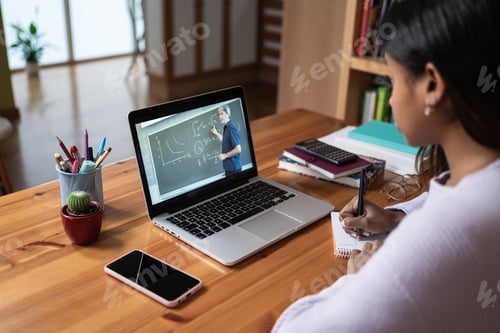 Preview: Student taking notes watching online video class with Math Teacher from home