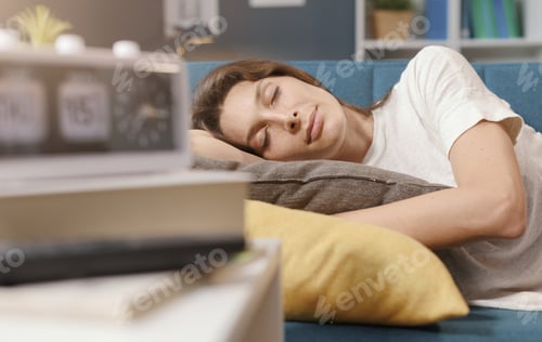 Preview: Relaxed woman sleeping on the sofa at home