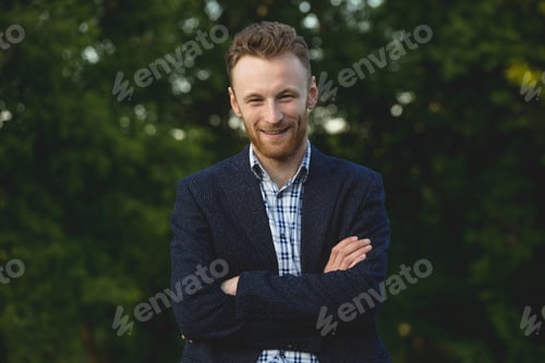 Preview: Handsome young man smiling outdoors