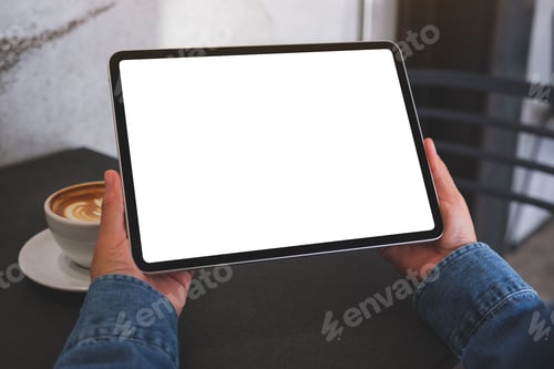 Preview: Mockup image of a woman holding digital tablet with blank white desktop screen in cafe