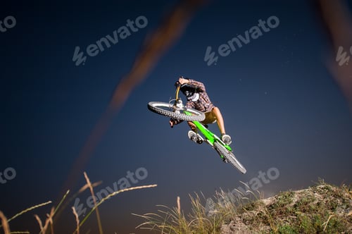 Preview: Cyclist riding downhill on mountain bike on the hill