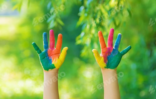 Preview: child with painted hands and legs. Selective focus.