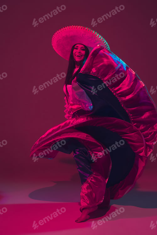 Preview: Fabulous Cinco de Mayo female dancer on purple studio background in neon light
