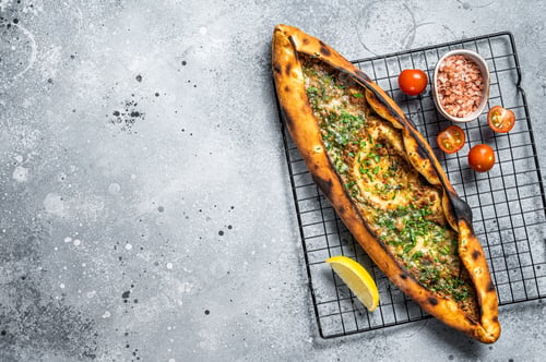 Preview: Turkish pide, traditional pie with beef meat and vegetables. White background. Top view. Copy space