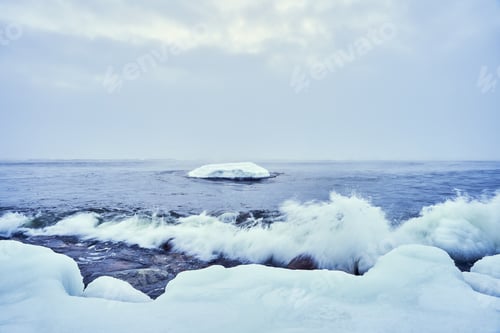Preview: Beautiful winter landscape featuring the cloudy sky over floating ice and sea waves