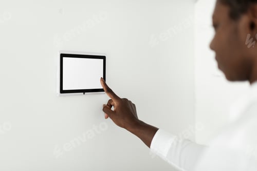 Preview: Woman pressing on smart home automation panel monitor