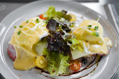Preview: Top of Egg benedict sandwiches in white plate. - muffin with poached egg, ham