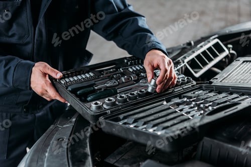 Preview: partial view of mechanic with tool case in auto repair shop