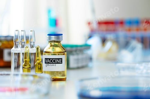 Preview: Vaccine in vial for injection on table against background of laboratory