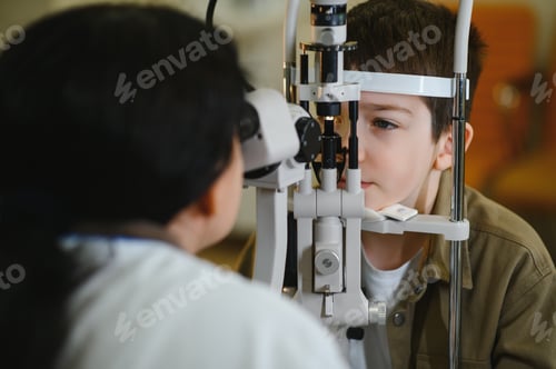 Preview: Ophthalmologist examining boy's vision with slit lamp biomicroscope