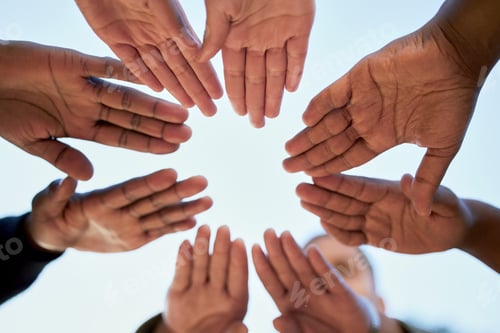 Preview: Shot of a group of unrecognizable students joining hands while standing outside