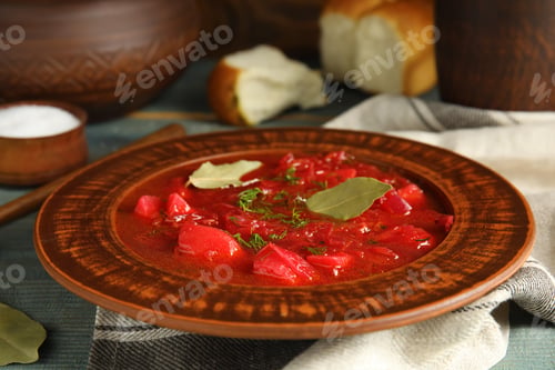 Preview: Stylish brown clay plate with Ukrainian borsch served on wooden table