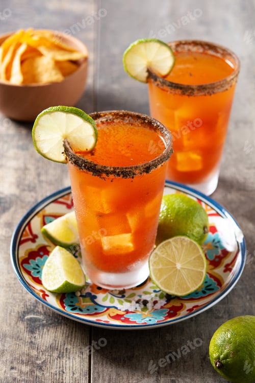 Preview: Homemade michelada cocktail with beer, lime juice,hot sauce,salted rim and tomato juice