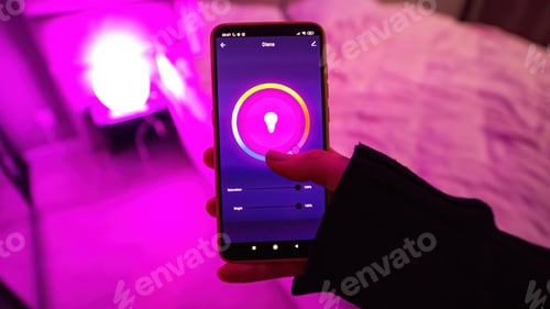 Preview: Female hand holding a smartphone with illumination controll app