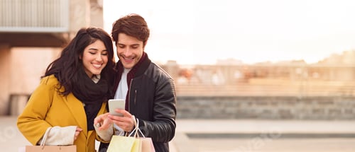Preview: Couple Enjoying Mobile Phone Outdoors After Shopping