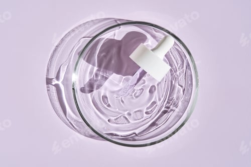 Preview: A pipette with a serum texture in a petri dish on a purple background.
