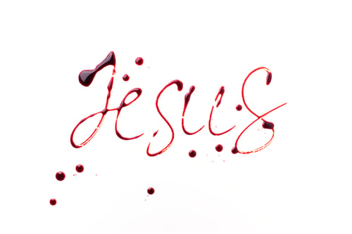 Preview: Name Jesus written with blood isolated on white background. Top view. Palm Sunday, Good Friday