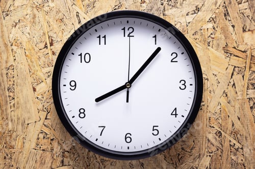 Preview: Clock watch at wooden chipboard of wall surface background