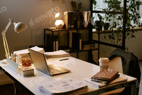 Preview: Modern Office Desk Displaying Laptop Documents and Coffee during Business Planning
