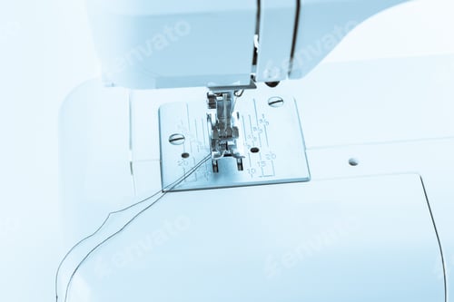 Preview: Sewing machine in use during daylight hours showcasing needle and thread activity