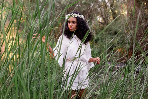 Preview: relaxed beautiful young afro american woman at sunset. Lifestyle and nature