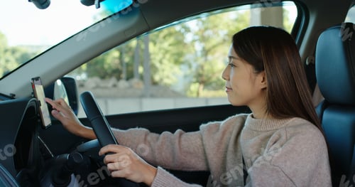 Preview: Woman set gps location on cellphone inside a car