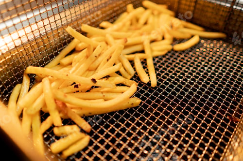 Preview: kitchen in the hotel restaurant, delicious freshly prepared French fries lie in the fryer close-up