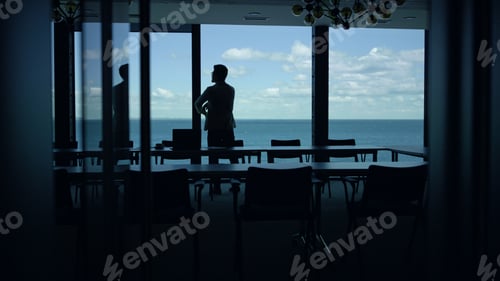 Preview: Businessman silhouette watching sea view big window. Entrepreneur taking break