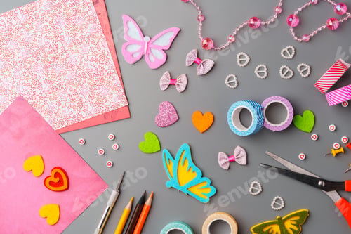 Preview: Crafting supplies arranged for a DIY project on a gray table with scissors, washi tape, and