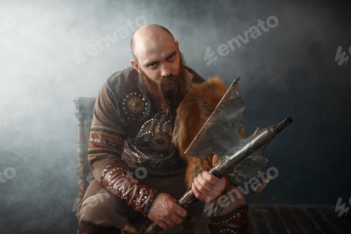 Preview: Bearded viking with axe sitting on chair