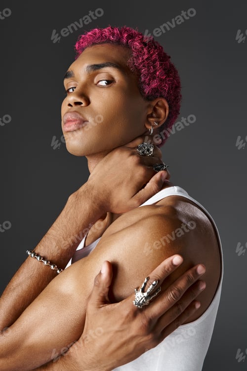 Preview: portrait of handsome man with crossed arms and one hand on neck looking at camera, fashion and style