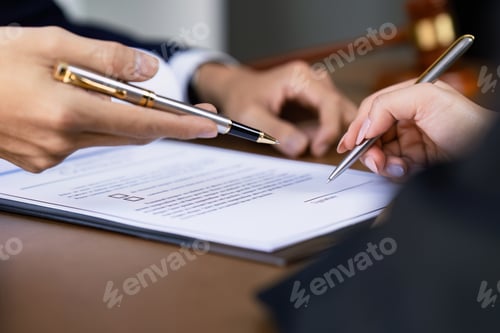 Preview: Hands of lawyer pointing at paper for businessperson signing contract. Solicitor, legal advisor
