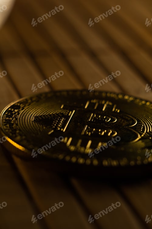 Preview: Closeup shot of a bitcoin coin on a wooden surface