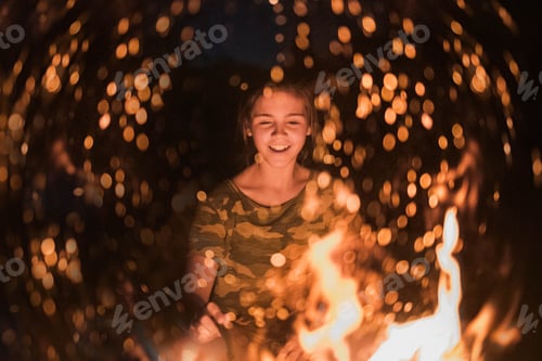 Preview: Young preteen at a camp fire