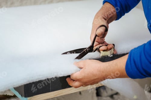 Preview: Furniture maker cutting a sofa padding