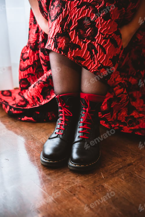 Preview: Woman in dress lacing boots