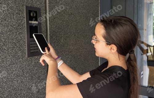 Preview: teenage girl using phone scan to digital door lock security systems at home.