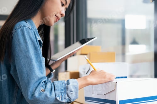 Preview: sweet young female business woman holding noteboard checking stock goods.