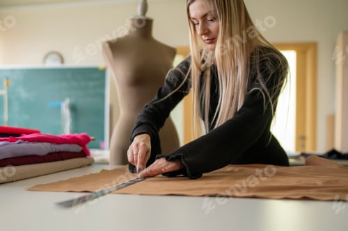 Preview: Designer uses a ruler to mark a fabric with chalk