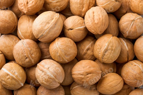 Preview: Walnut nuts texture. Food background. Top view. Close up.
