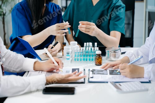 Preview: Medical team having a meeting with doctors in white lab coats and surgical scrubs seated