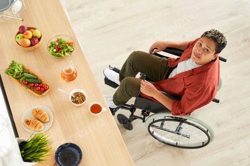 Preview: Disabled woman with healthy food on the table