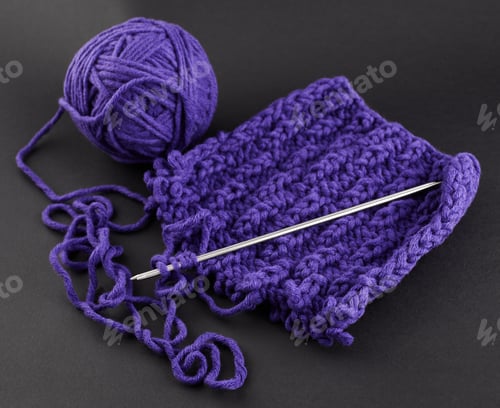 Preview: A Piece Of Purple Knitting, Against A Dark Background