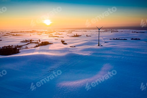 Preview: Wind turbine on snowy field. Agriculture and alternative energy, winter