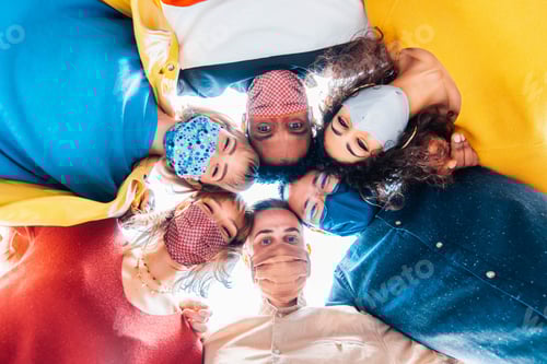 Preview: Multiracial group of friends wearing protective face masks taking a selfie