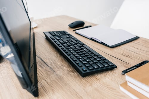Preview: closeup view of computer keyboard and mouse, textbooks and pens on wooden table