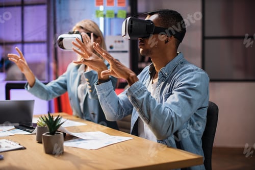 Preview: Company workers wearing VR headset during meeting