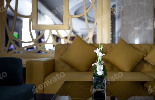 Preview: Living room interior with flowers in a vase on the table.